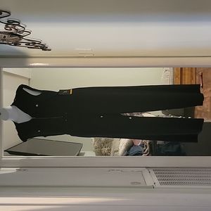 Black one piece, sleeveless jumpsuit with gold zipper and accents